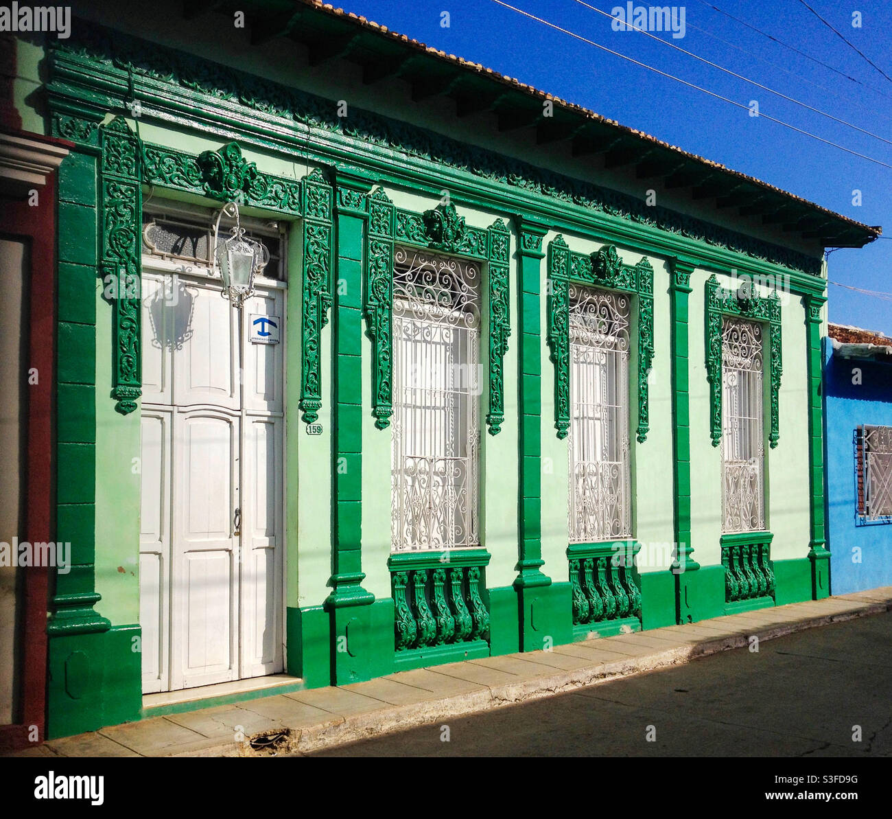Picturesque colourful decorative house front in small street, Trinidad, Cuba - Smartphone Captured Stock Image
