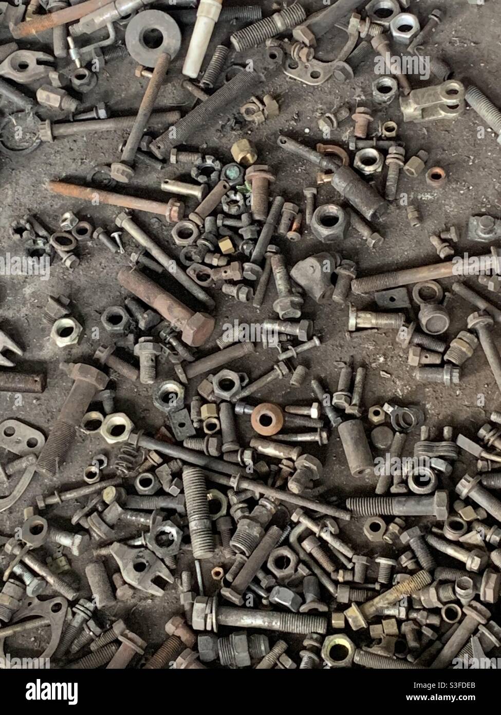 Nuts and bolts on garage floor Stock Photo Alamy