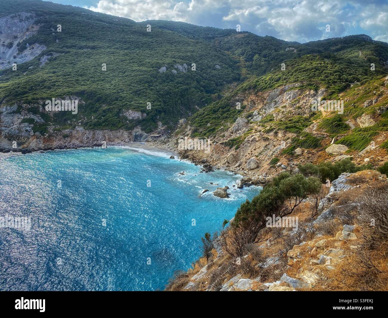 View at Lalaria beach surrounded by cliffs on the North of Skiathos island. - Smartphone Captured Stock Image