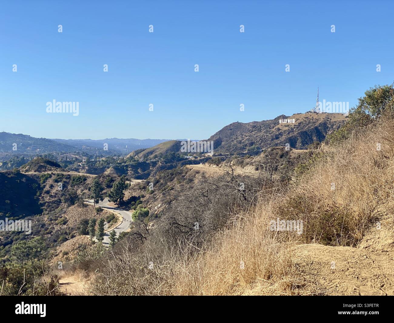 LOS ANGELES, CA, NOV 2020: Hollywood sign and trails in Griffith Park, Los Angeles, CA, on a cloudless November day with blue skies overhead - Smartphone Captured Stock Image