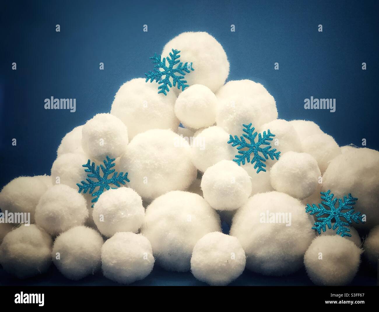 Pile of fake snowballs and snowflakes against a blue background Stock Photo  - Alamy