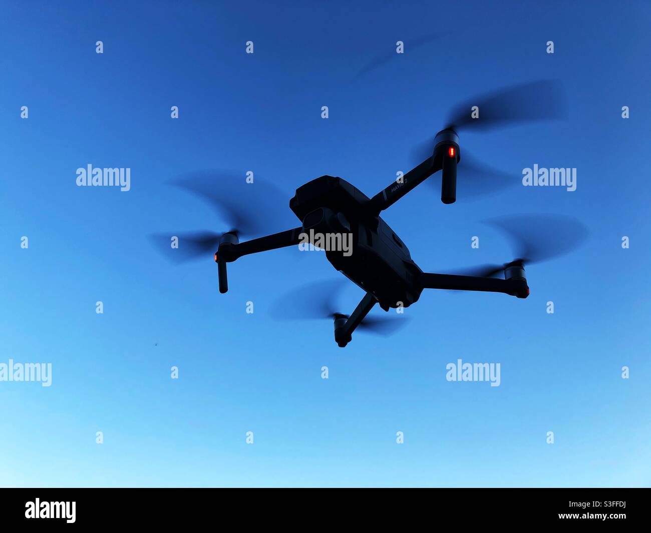Low angle view of a drone with lights on in the dark with copy space - Smartphone Captured Stock Image