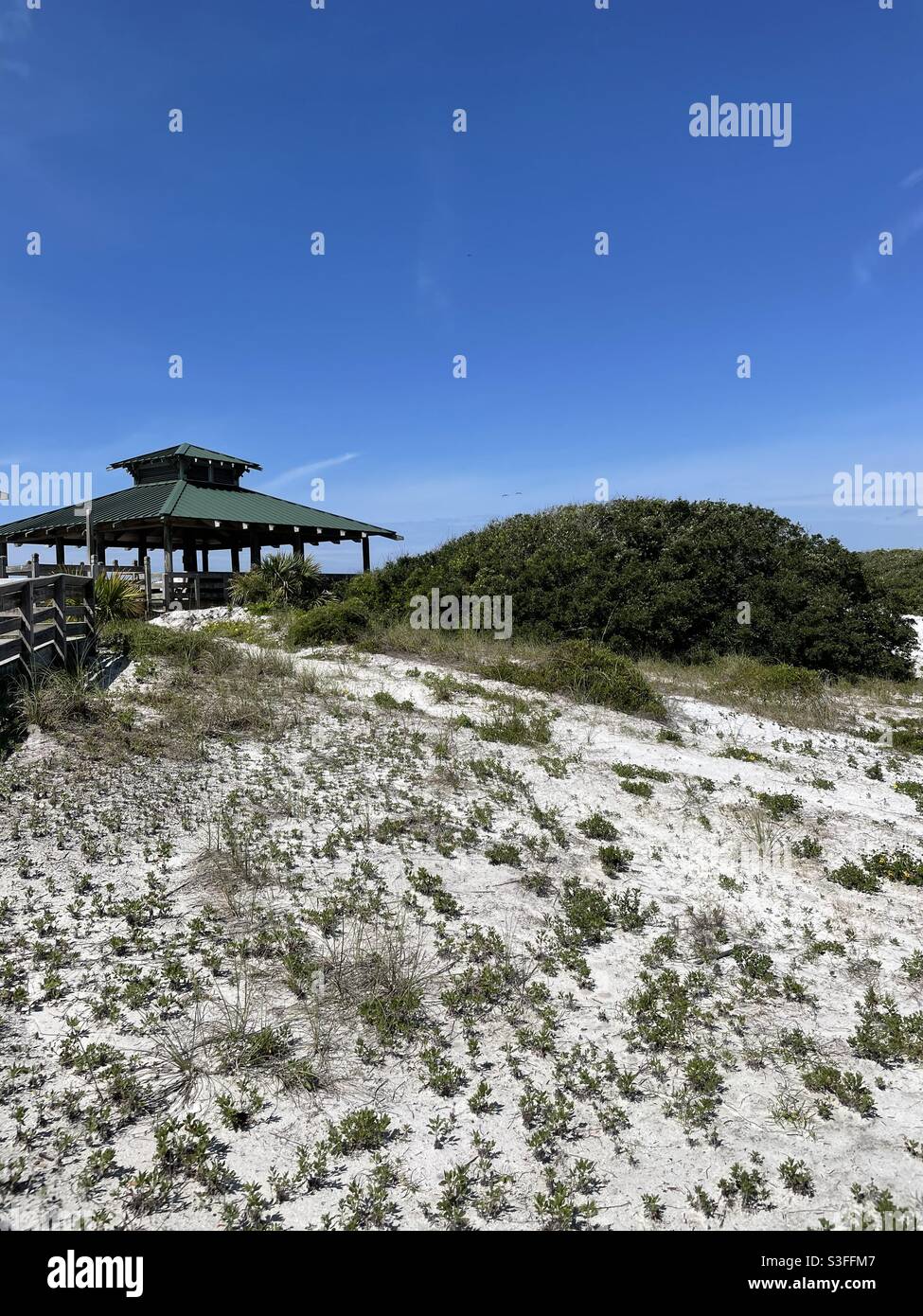 Street view of white sand dunes and public picnic pavilion at John Beasley park fort Walton Beach Florida Stock Photo