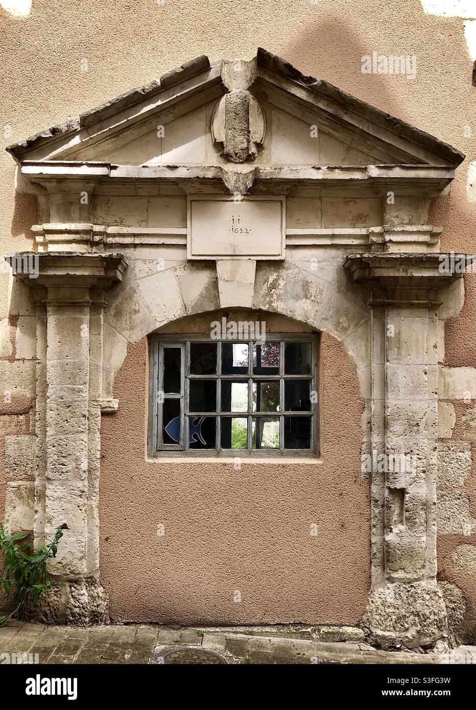 Ornate 17th century doorway blocked in modern times for a window - Le Blanc, Indre (36), France. Stock Photo