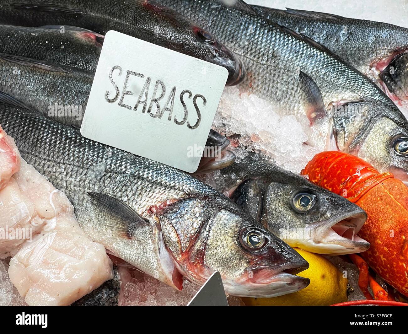 Sea bass on ice in a restaurant display counter Stock Photo