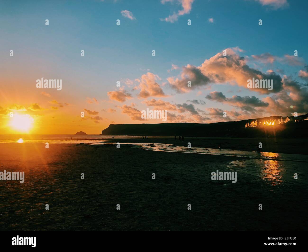 Sunset reflecting on houses on a beach in Cornwall - Smartphone Captured Stock Image