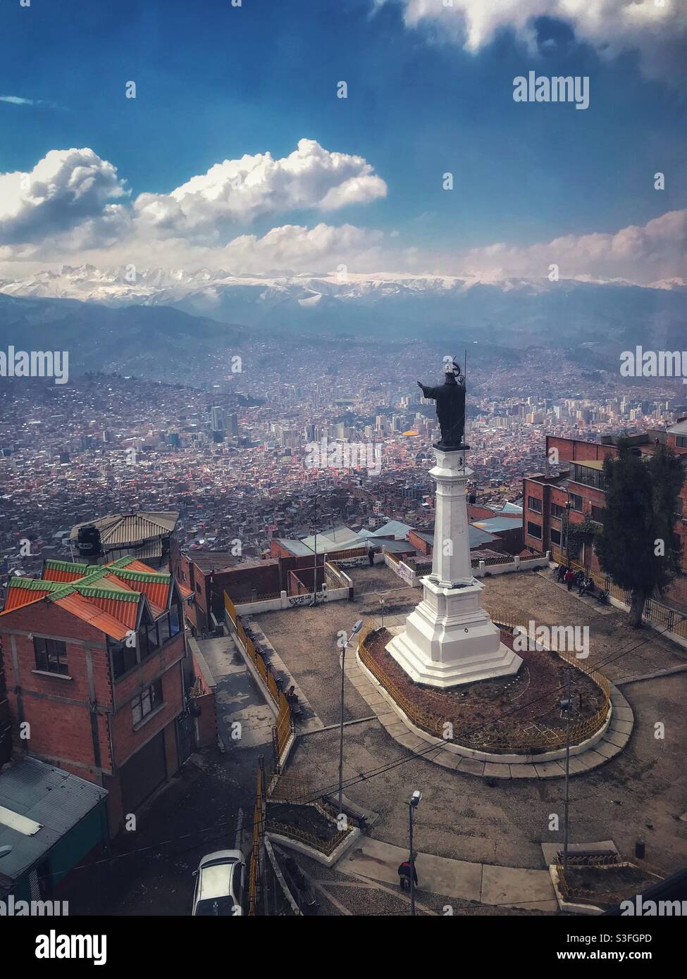 A religious Statue looks over La Paz, Bolivia from the neighboring city of El Alto Stock Photo