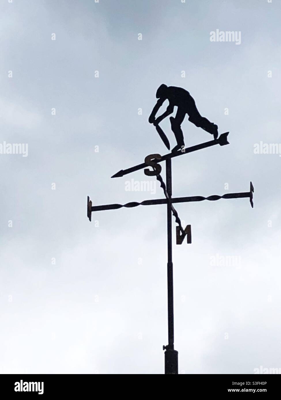 A cricket weather vane with old Father Time batting at Lord’s Cricket Ground - Smartphone Captured Stock Image