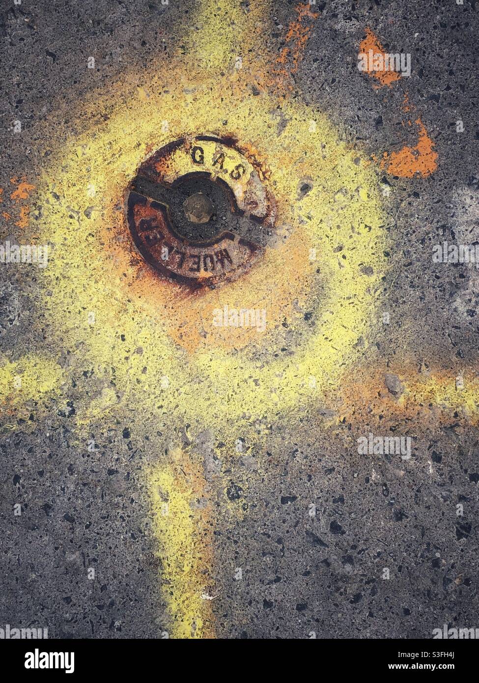 Natural gas fitting cover marked for repair works on the paved surface, 2021 - Smartphone Captured Stock Image