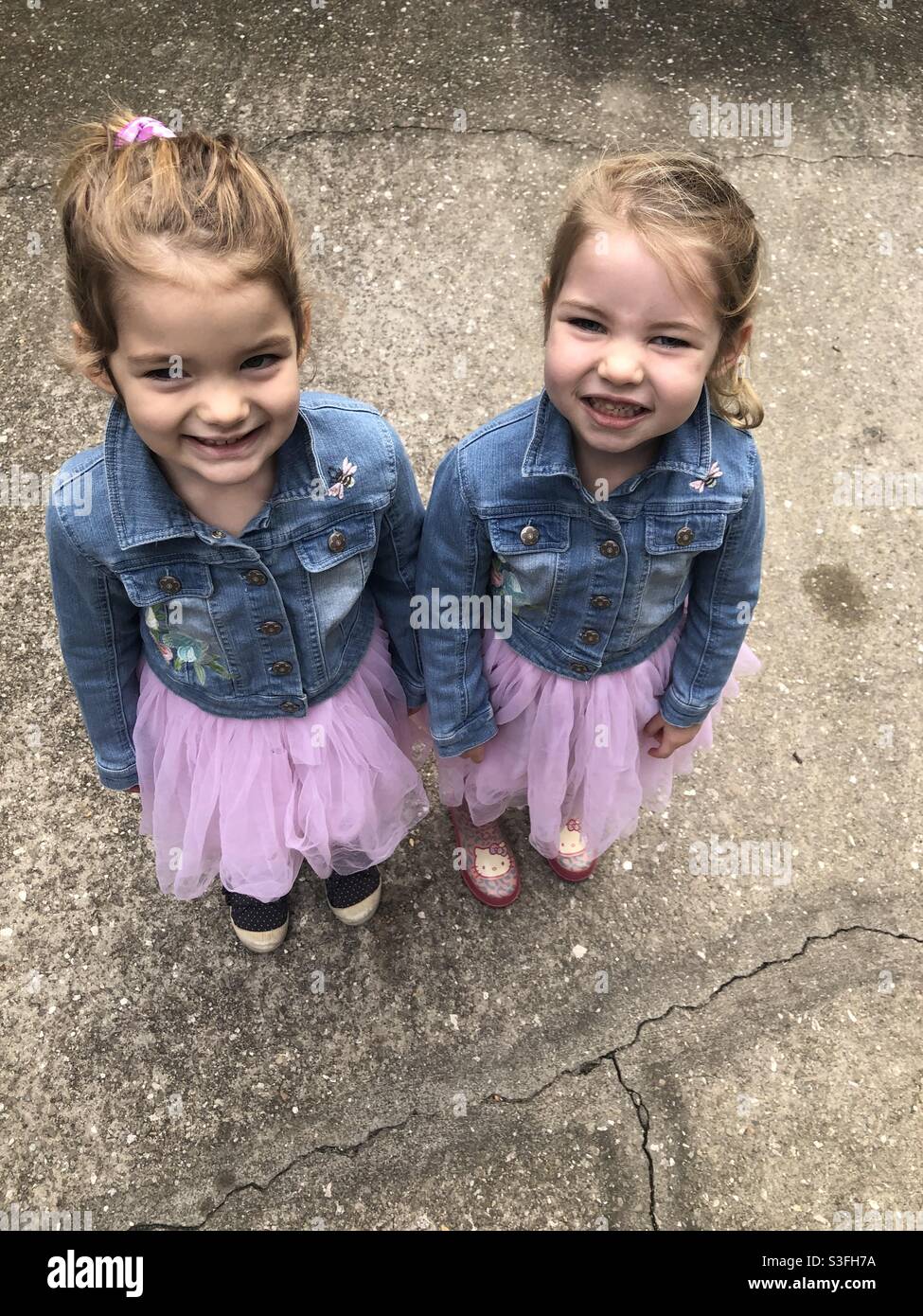 Twin girl in jean jackets Stock Photo