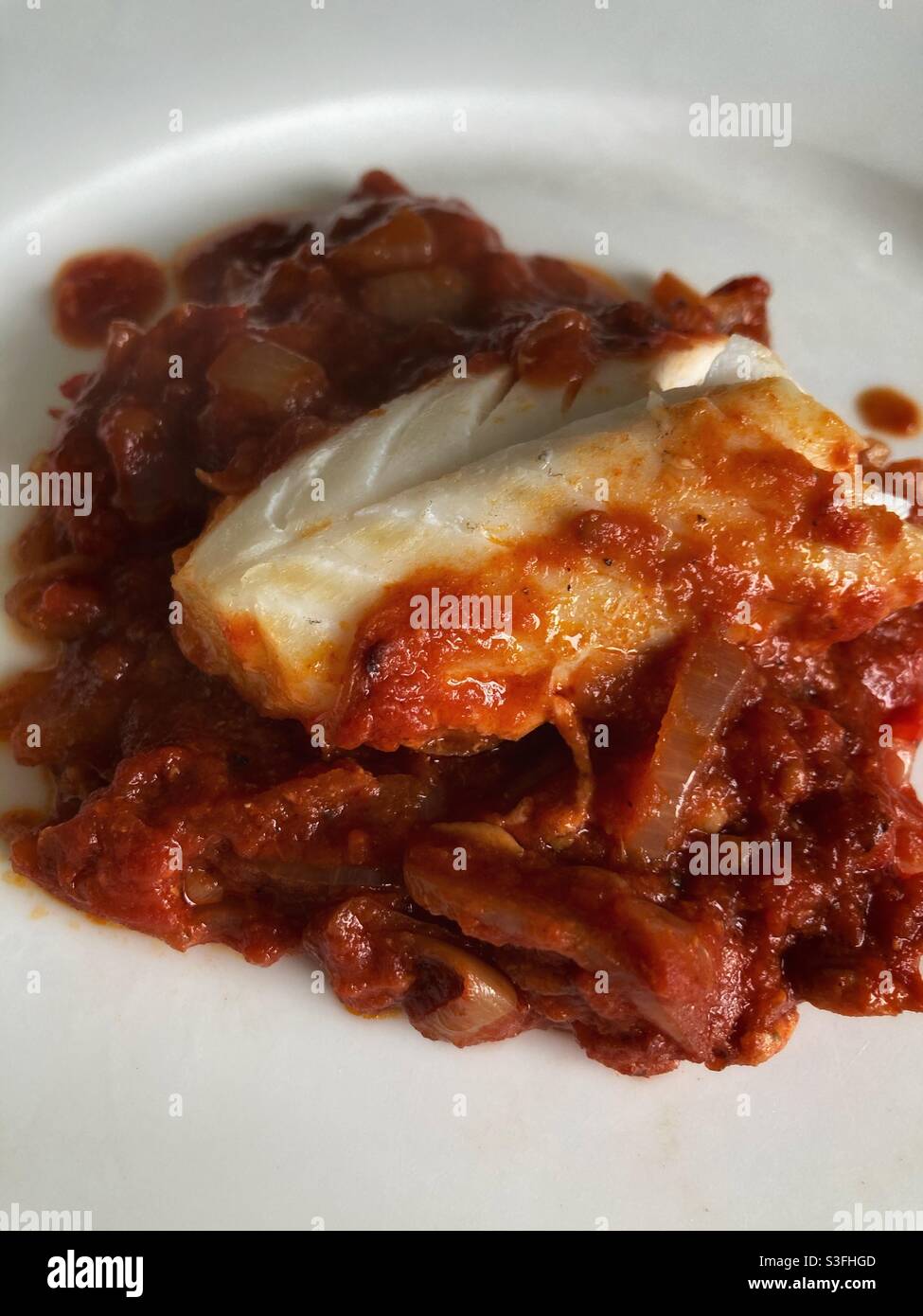 Fish in tomato sauce Stock Photo Alamy