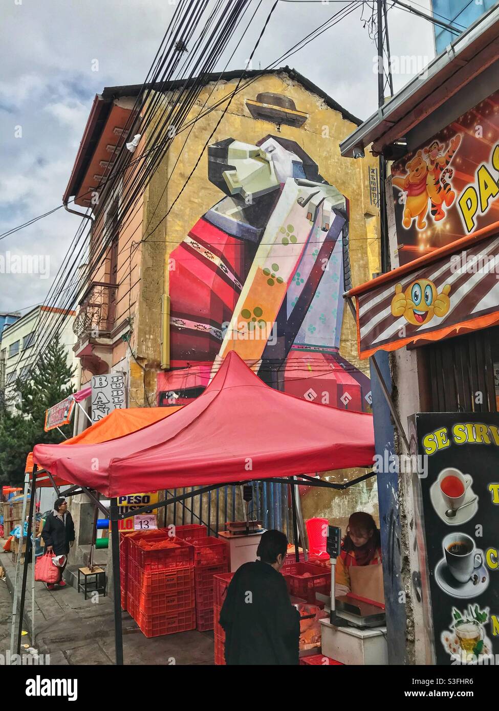 Street art overlooking a market stall in La Paz, Bolivia - Smartphone Captured Stock Image