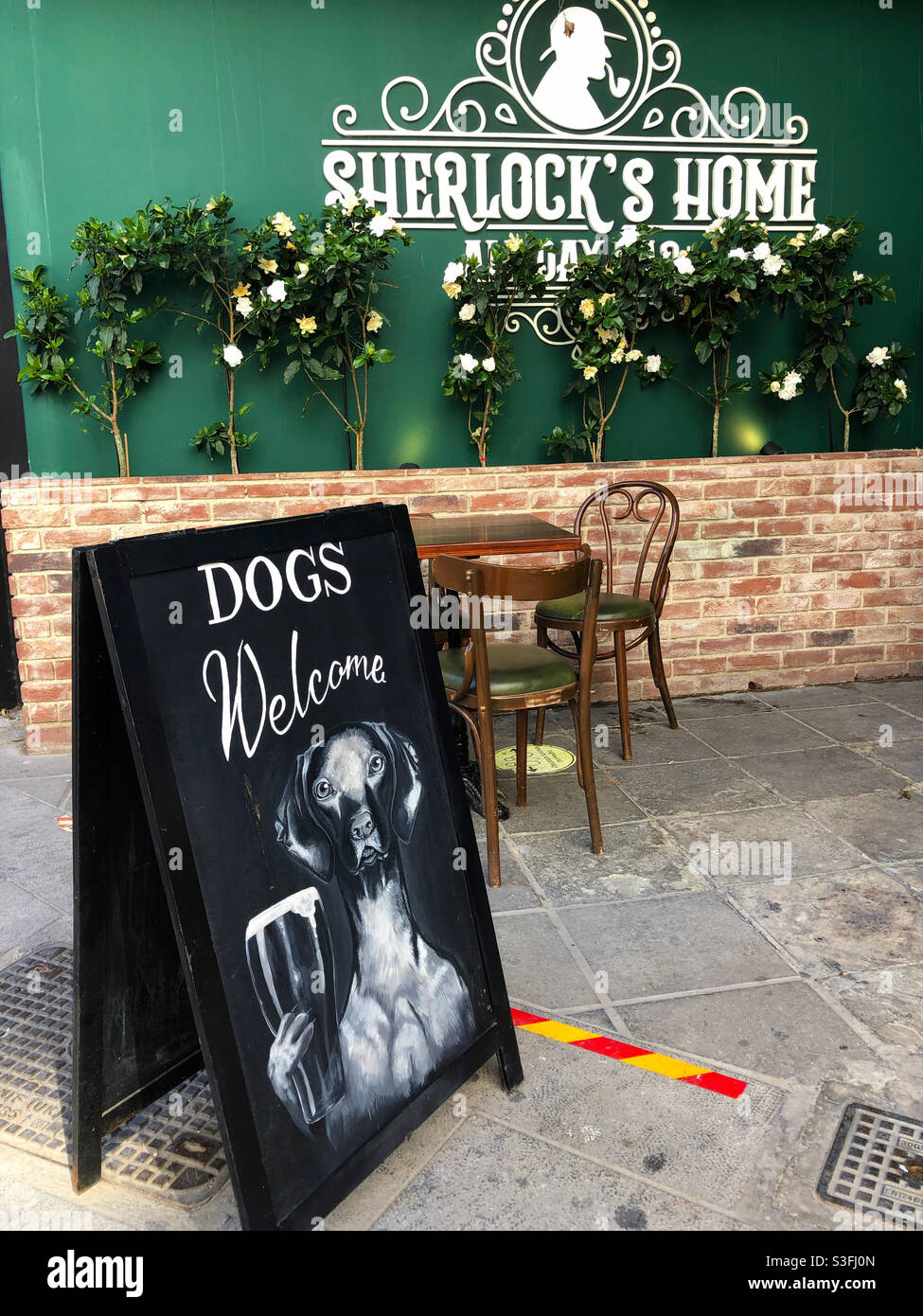 Dogs Welcome sign at Sherlock’s Home Bar and restaurant, Limassol Cyprus. Stock Photo