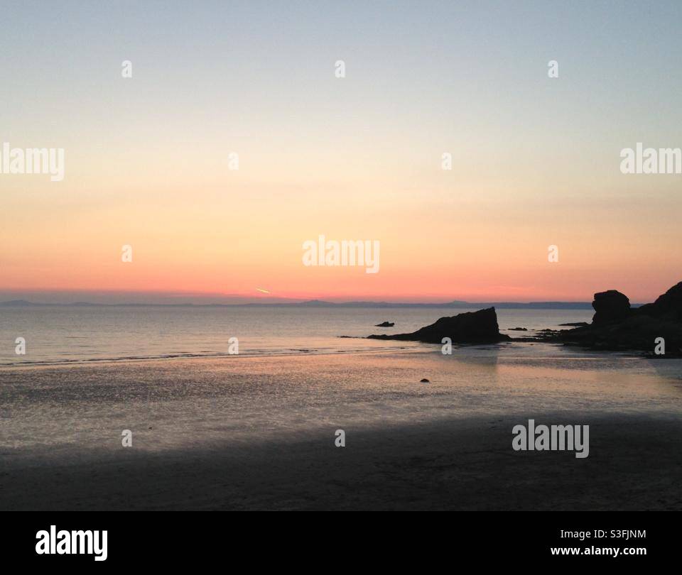 Breathtaking sunset on Broad Haven Beach in Pembrokeshire Wales UK Stock Photo