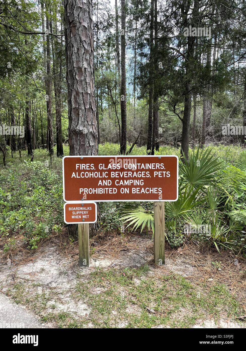 Restrictions sign at Blackwater River State Park Florida with forest