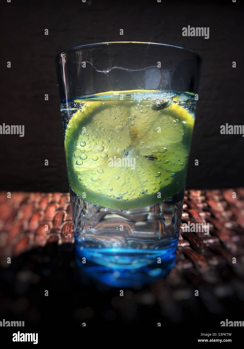 Sparkling water served with a slice of lemon - Smartphone Captured Stock Image