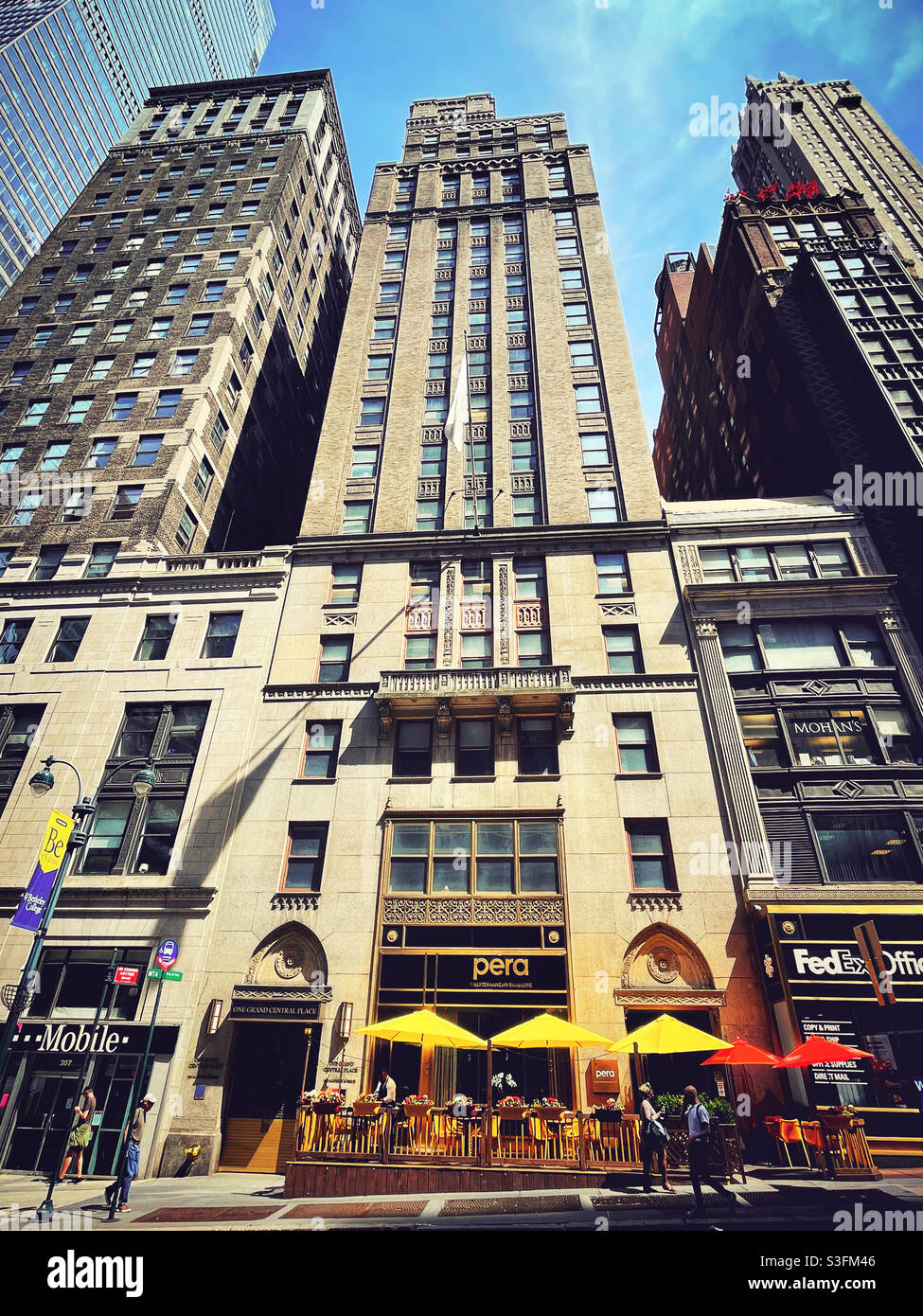 Colorful umbrellas in the outdoor dining area at the upscale  restaurant Perambulation, midtown Manhattan, NYC, USA - Smartphone Captured Stock Image