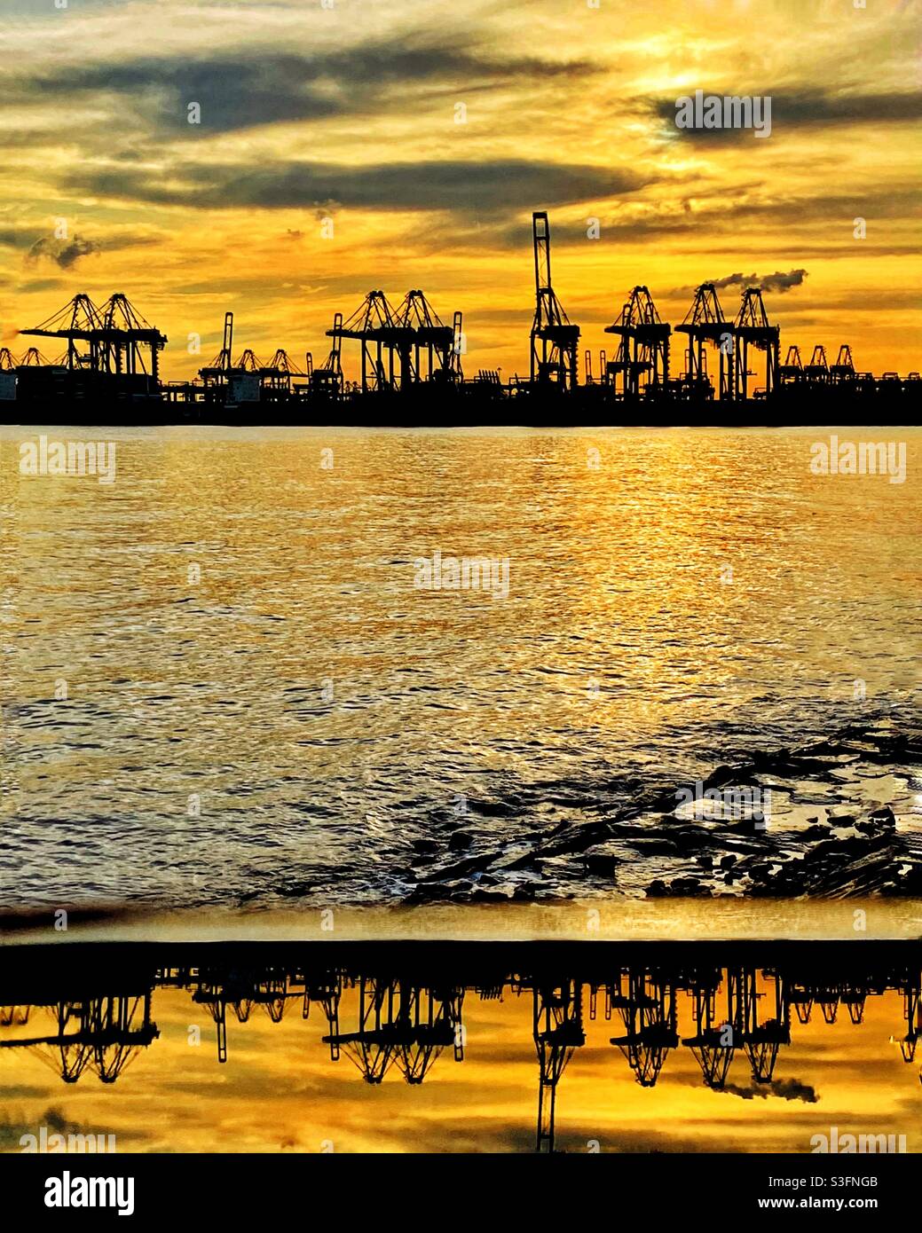 Reflections of a harbor at sunset Stock Photo