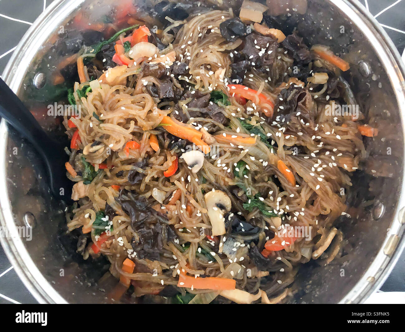 Korean style noodles with vegetables and sesame seeds. Stock Photo