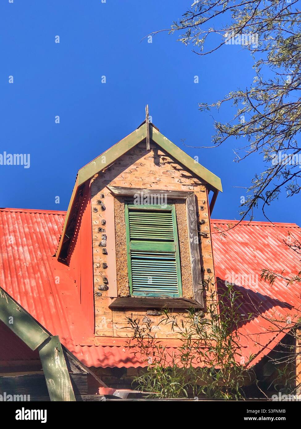 Green boarded up window of an abandoned house - Smartphone Captured Stock Image