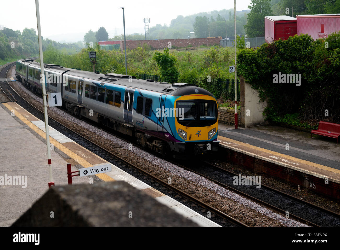 Diesel train running through Morley Station in Leeds West Yorkshire