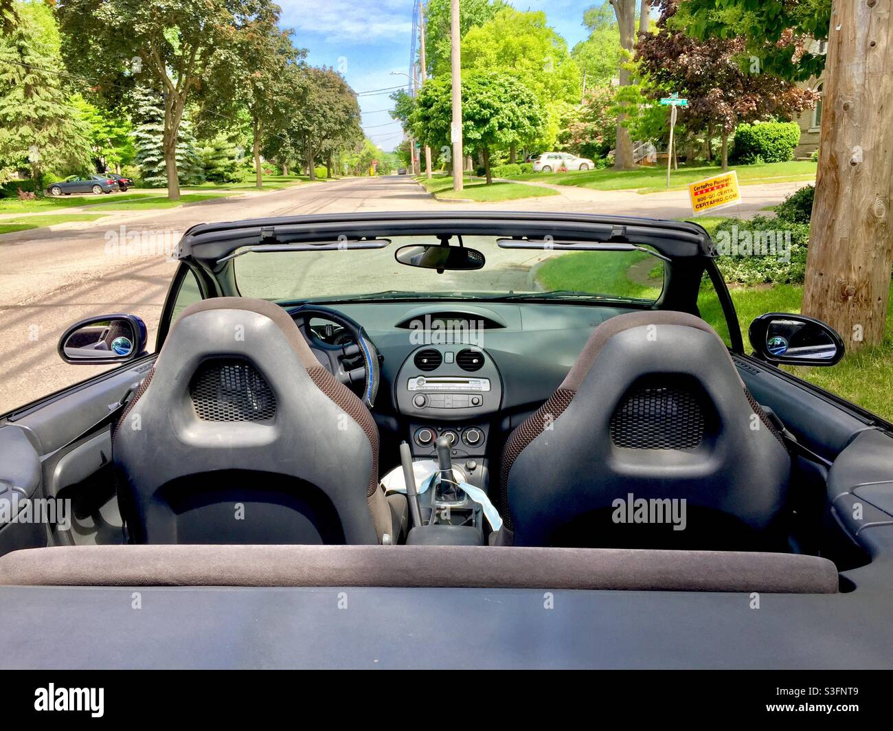 Convertible with open roof and masks parked on a lovely street, Ontario, Canada. - Smartphone Captured Stock Image Convertible with open roof and masks parked on a lovely street, Ontario, Canada. - Smartphone Captured Stock Image