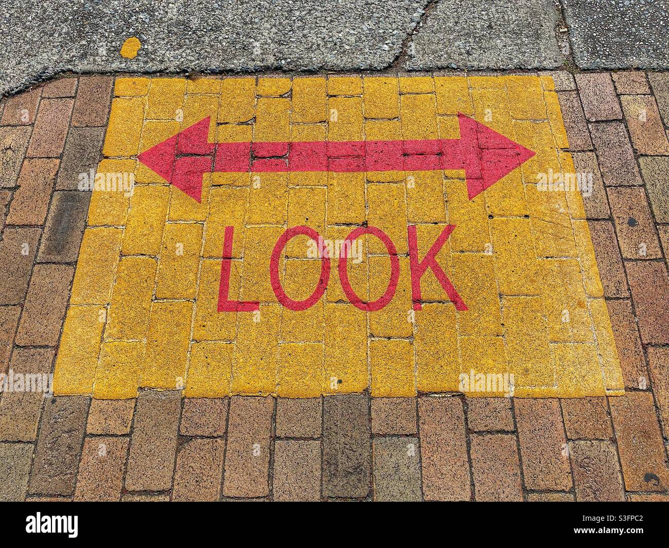 Look left and right signage on a footpath in Brisbane, Queensland, Australia - Smartphone Captured Stock Image
