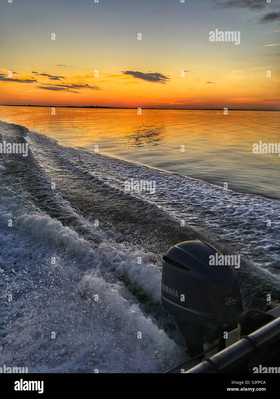 Speed boat wake at sunset Anclote Key Florida USA - Smartphone Captured Stock Image