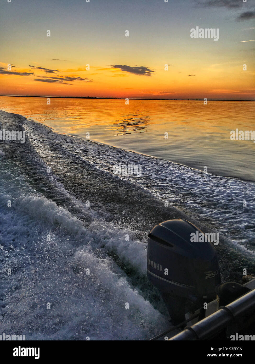 Speed boat wake at sunset Anclote Key Florida USA Stock Photo