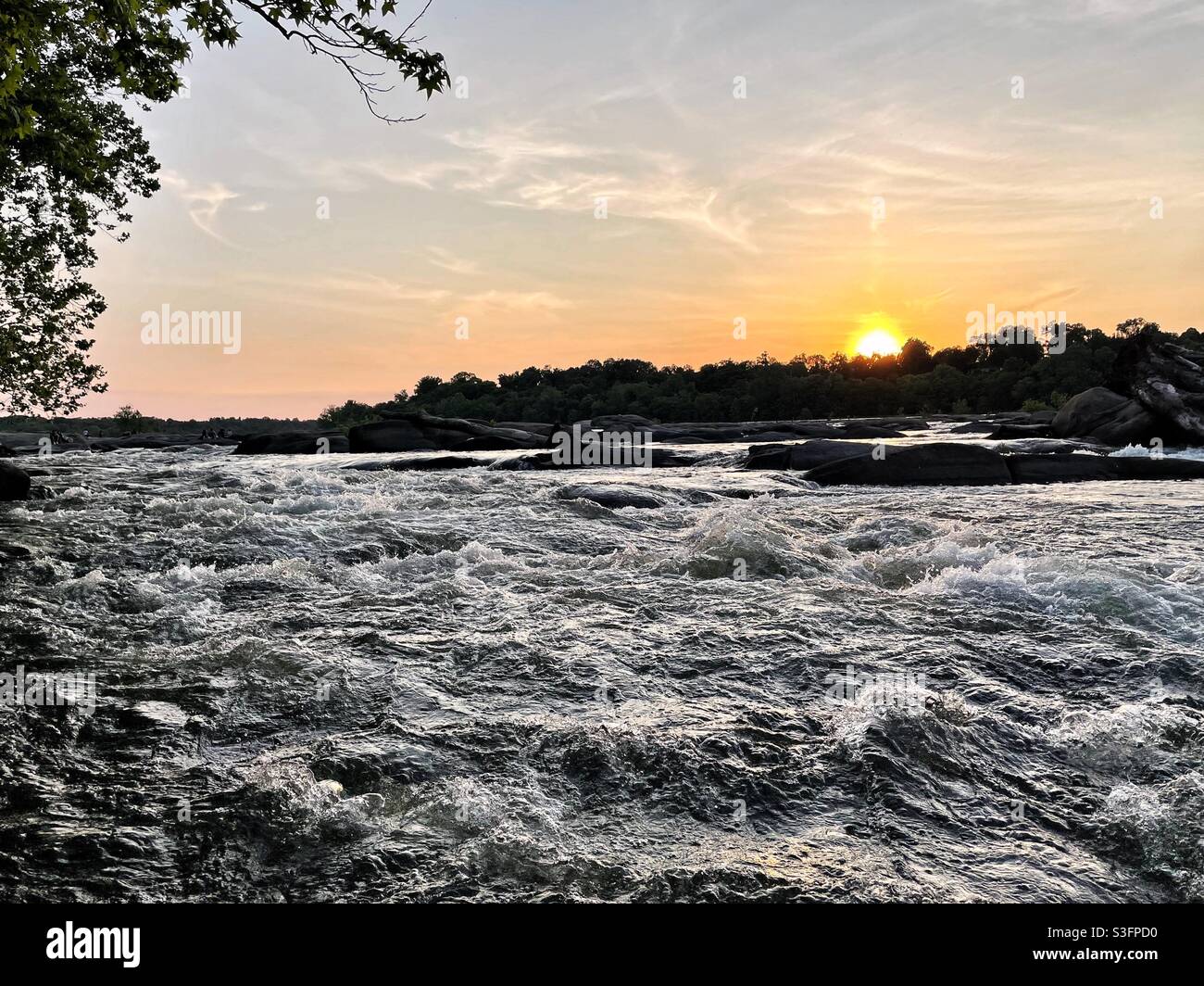 The sunset over the whitewater of the James River in Richmond, Virginia. Stock Photo