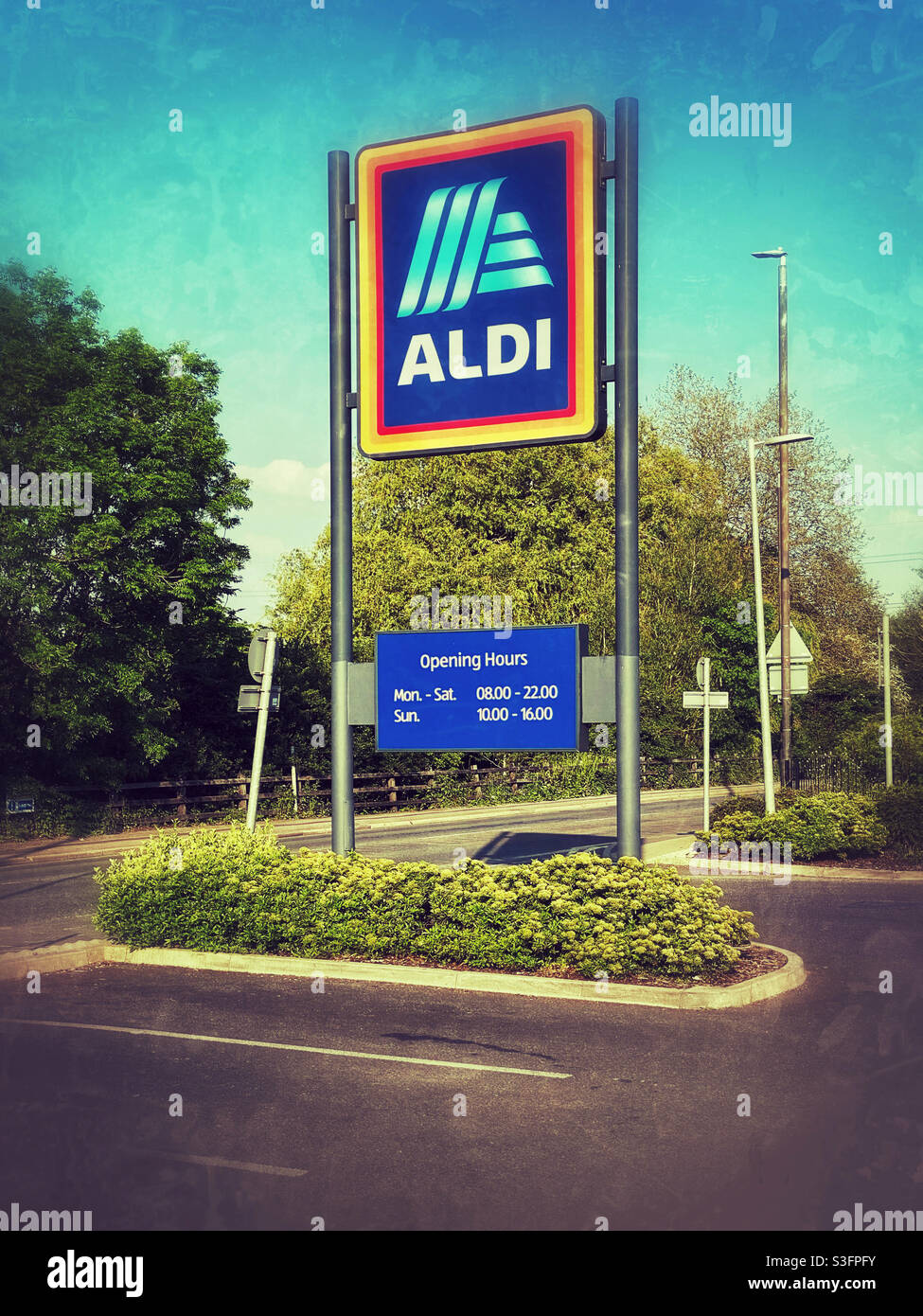 The famous Aldi logo on a big sign outside the food retailers car park entrance. Aldi is a discount British food retailer rapidly gaining market share. Photo credit - ©️ COLIN HOSKINS. - Smartphone Captured Stock Image
