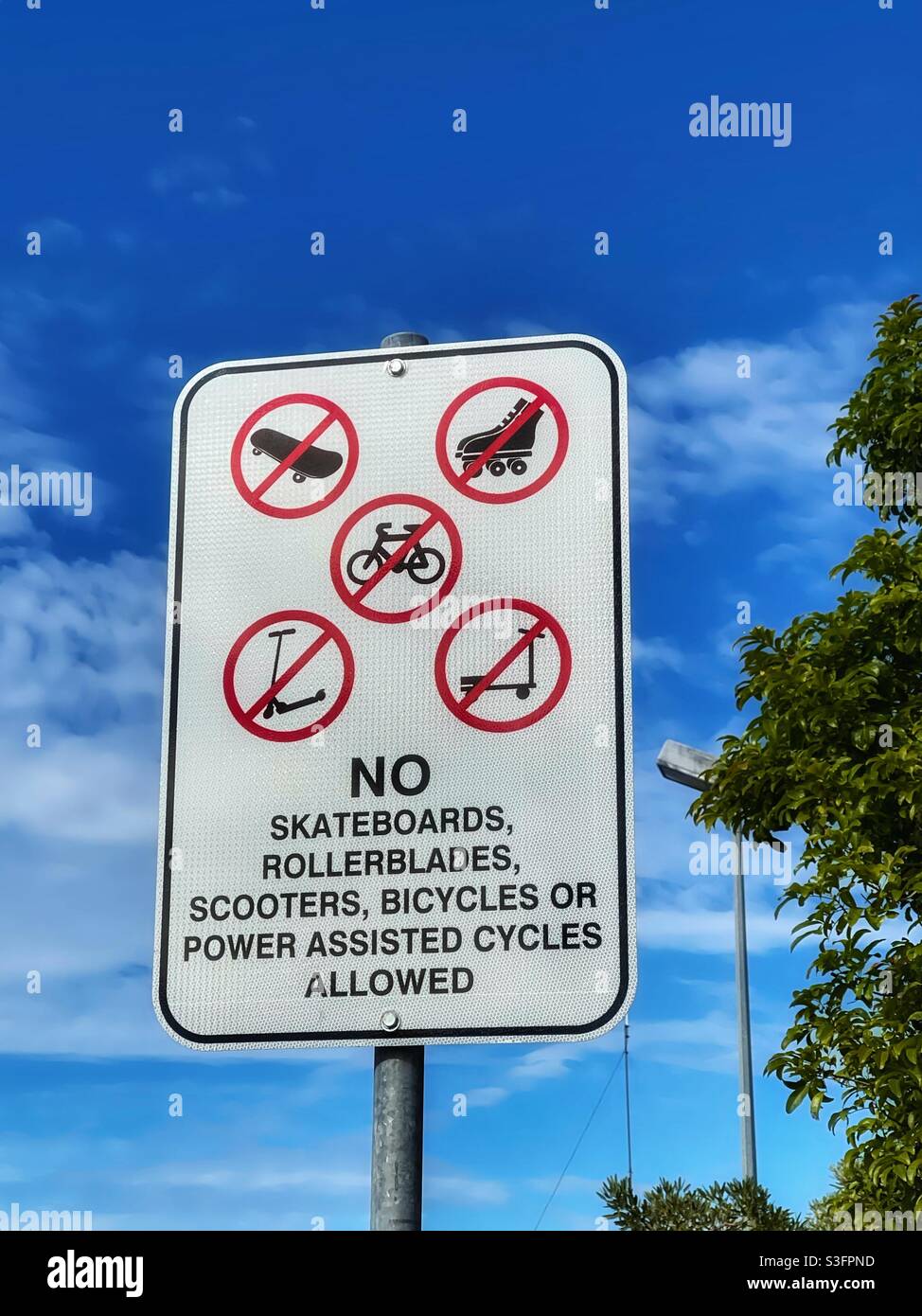 Restrictions sign banning skateboards, rollerblades scooters and cycles from a footpath - Smartphone Captured Stock Image