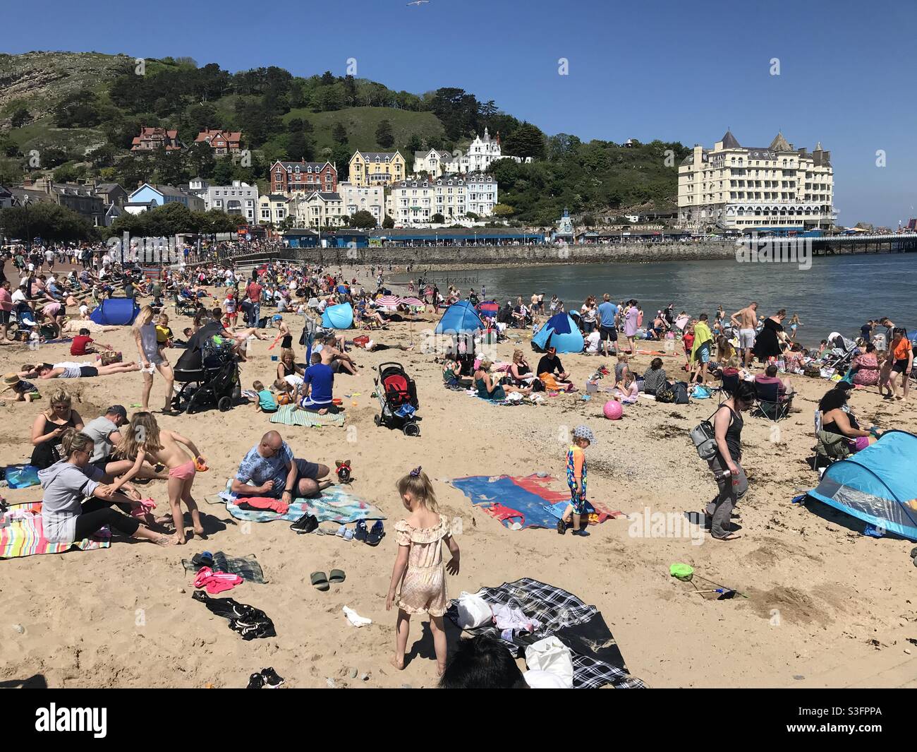 A packed beach in Llandudno, North Wales - Smartphone Captured Stock Image