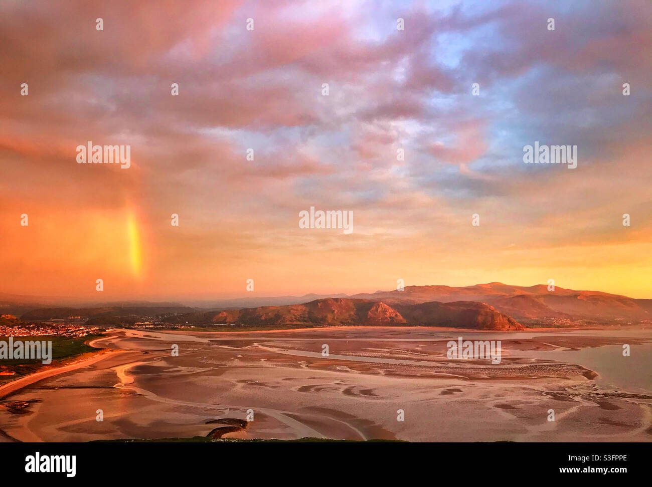 A spectacular view of a rainbow over the Conwy Valley and the Snowdonia Mountain range taken from the Great Orme, Llandudno, North Wales. - Smartphone Captured Stock Image