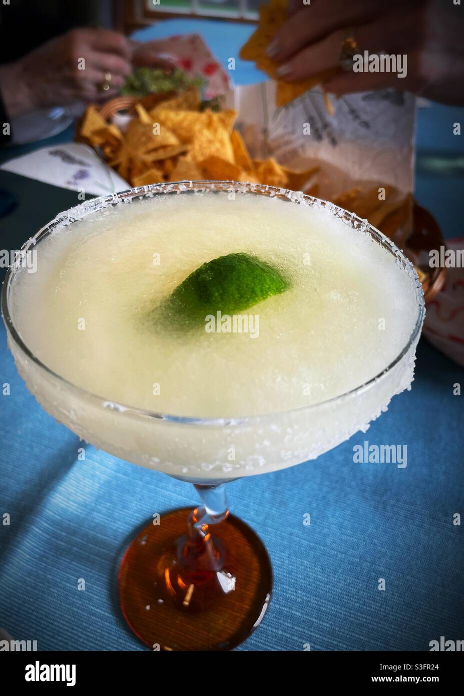Close up of a frozen margarita cocktail in a salted rim Glass Stock Photo