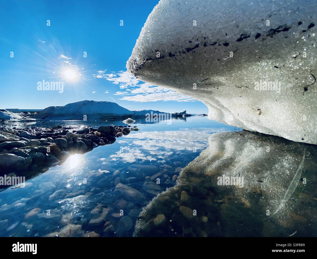 Beached ice floe from the annual break up of the sea and river ice in Kotzbue Sound in the Alaskan Arctic. Kotzebue, Alaska, USA Stock Photo
