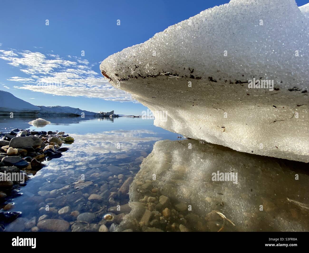 Beached ice floe from the annual break up of the sea and river ice in Kotzebue Sound in the Alaskan Arctic. Kotzebue, Alaska, USA - Smartphone Captured Stock Image