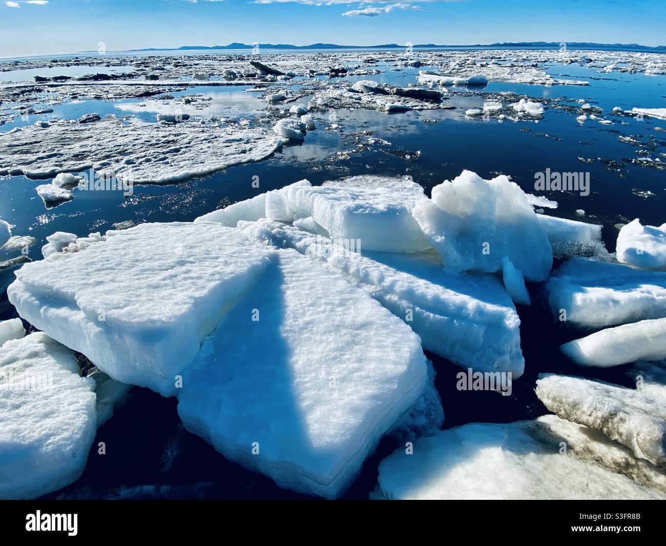 Melting ice floes from the annual break up of the sea and river ice in kotzebue sound in the Alaskan Arctic. Kotzebue, Alaska, USA - Smartphone Captured Stock Image