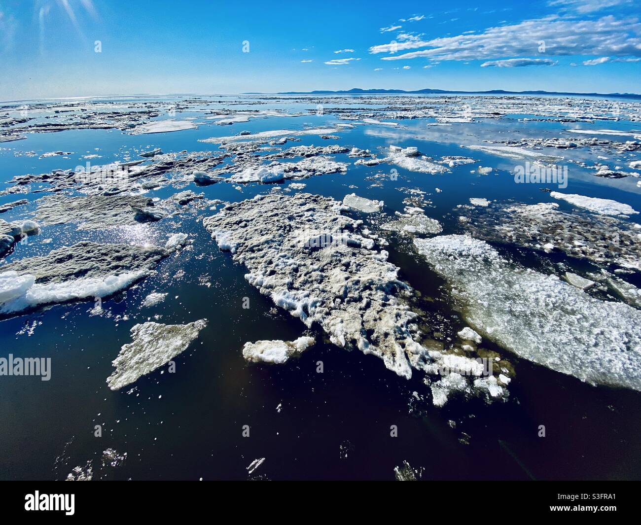 Melting ice floes in Kotzebue Sound from the annual spring break up of the sea and river ice in the Alaskan Arctic. Kotzebue, Alaska, USA Stock Photo