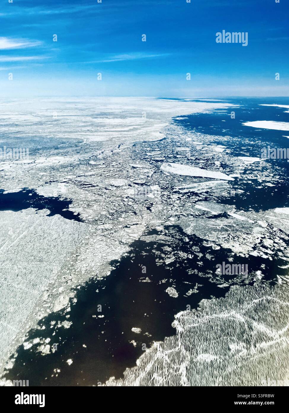 Melting sheets of sea ice in the Bering Strait/North Pacific Ocean northwest of Nome, Alaska in the annual spring break up Stock Photo