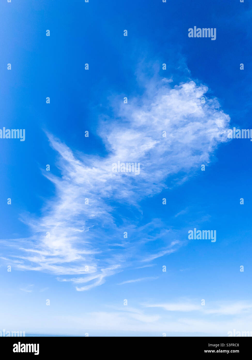 Wispy edges cloud on blue sky Stock Photo