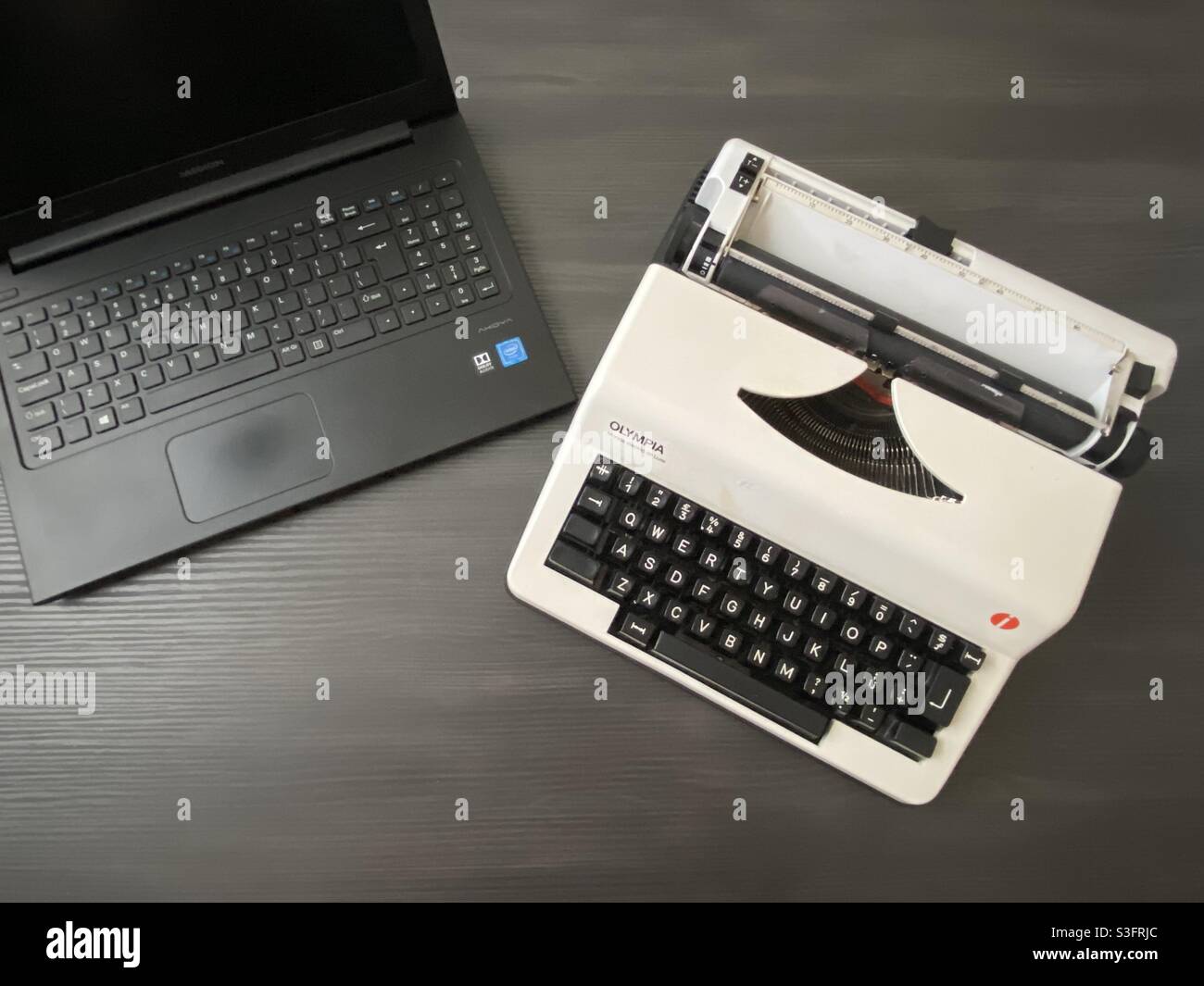 Laptop vs typewriter Stock Photo Alamy