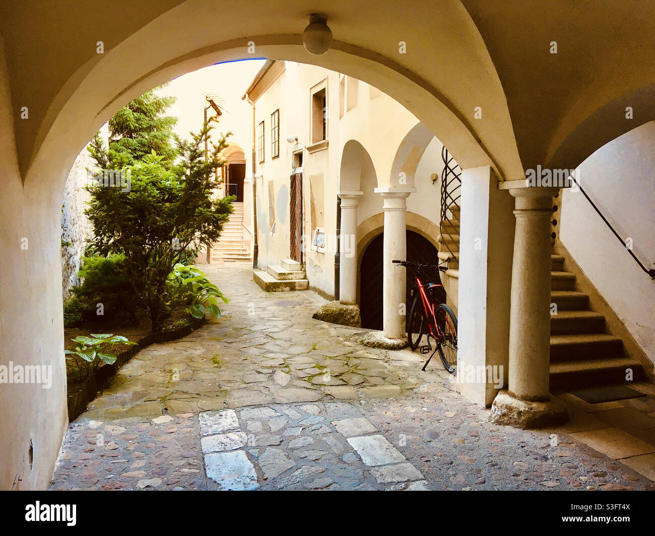 Medieval house inner courtyard, arches supported with columns, Varkerulet, Sopron, Hungary Stock Photo