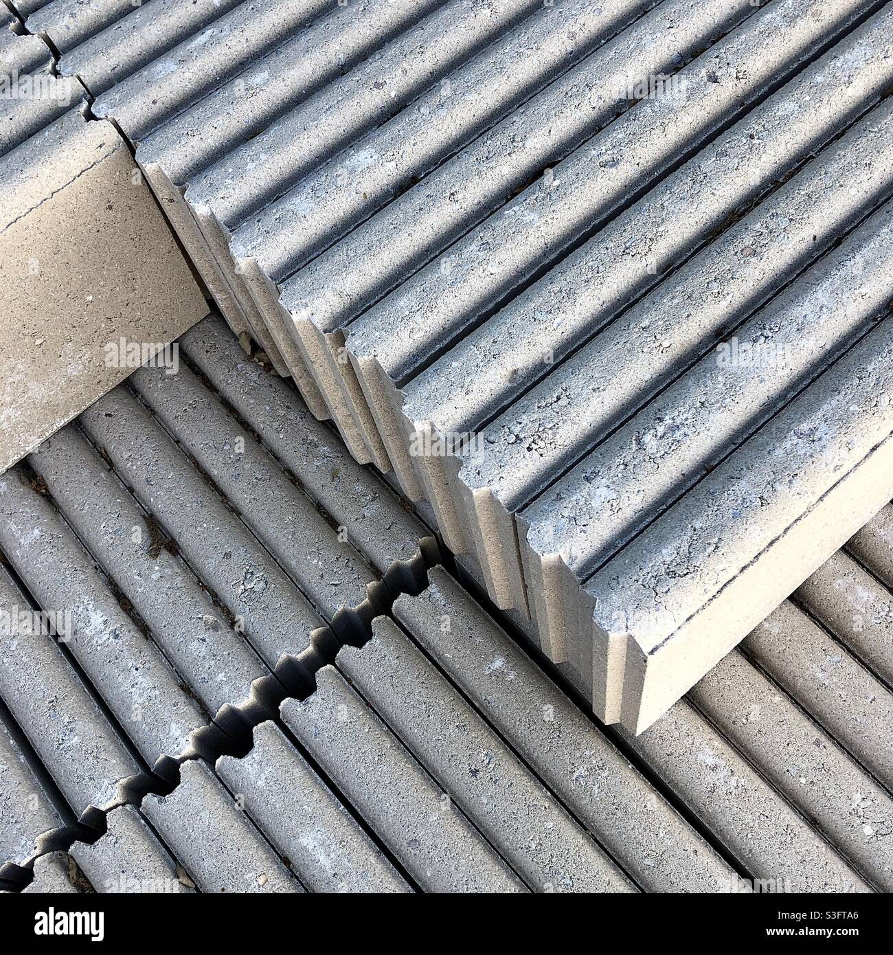 Pile of pre-cast concrete garden edging pieces. - Smartphone Captured Stock Image