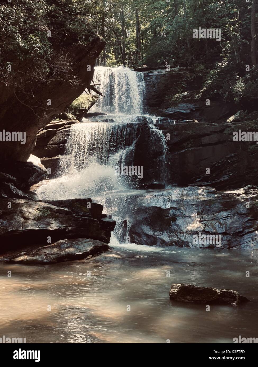 Multi-level waterfall flowing over rocks Stock Photo