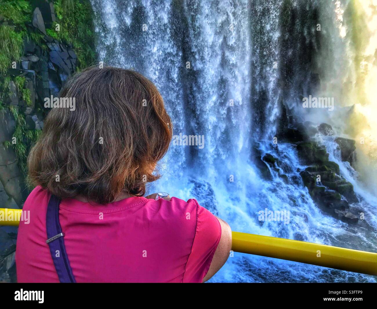 A woman viewing Iguazu falls on the Brazilian side - Smartphone Captured Stock Image