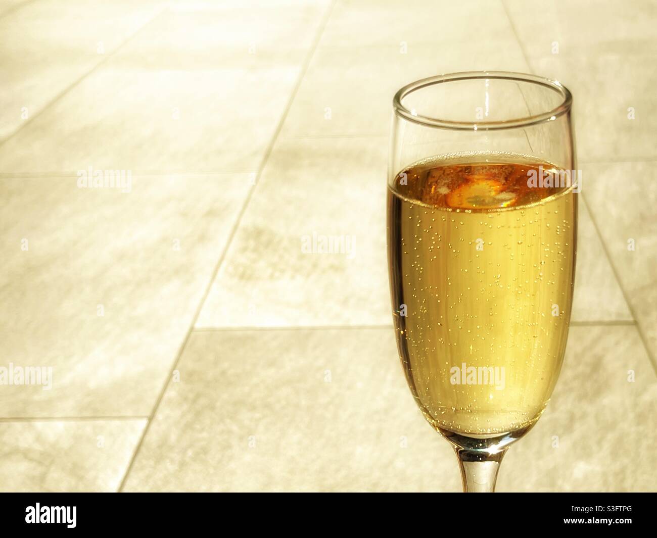 Flute glass of chilled champagne isolated against a plain background. No people. Stock Photo