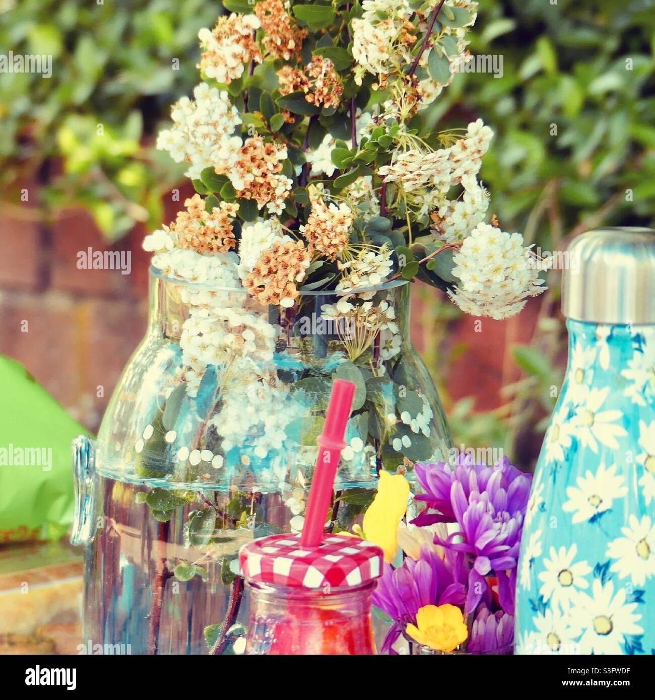 Vase of flowers at a garden party Stock Photo
