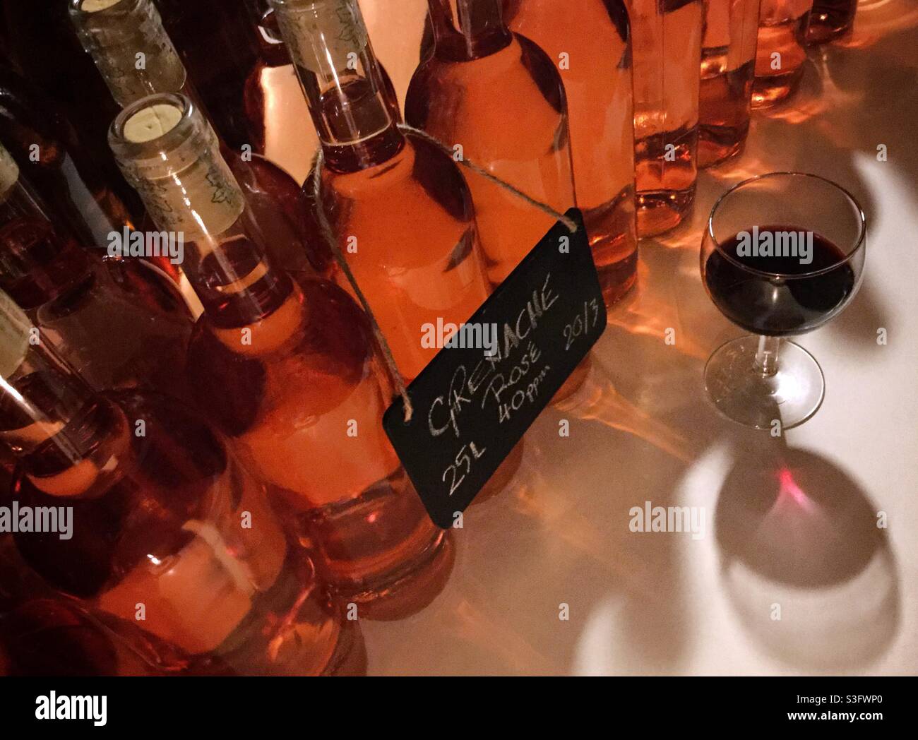 Bottle of Grenache rosé with a glass of Syrah wine, Catalonia, Spain. Stock Photo