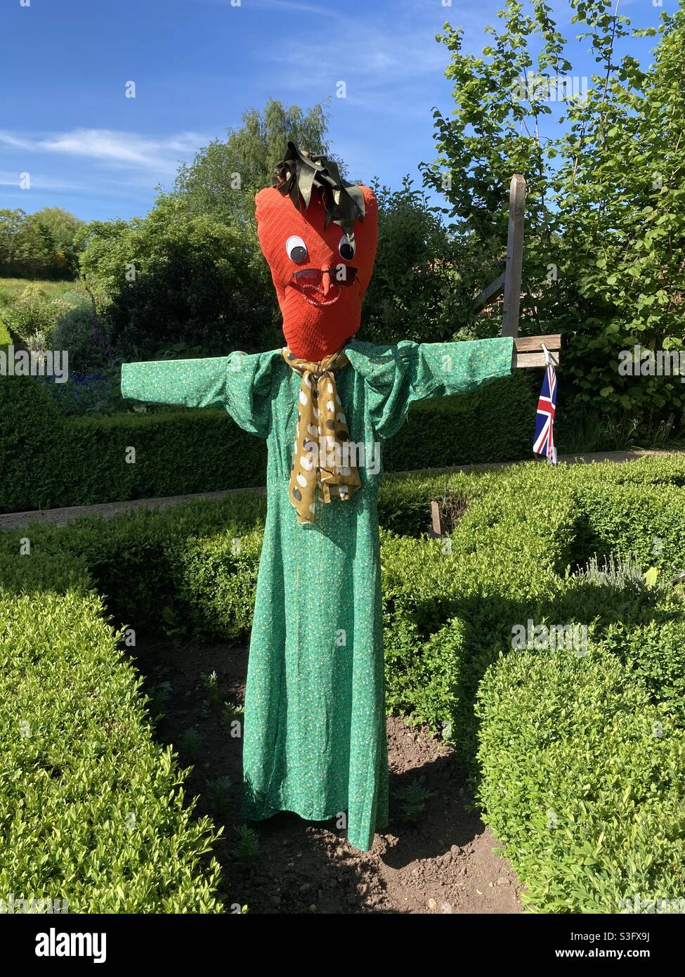 Strawberry themed scarecrow in walled garden, Allesley Park, Coventry. - Smartphone Captured Stock Image